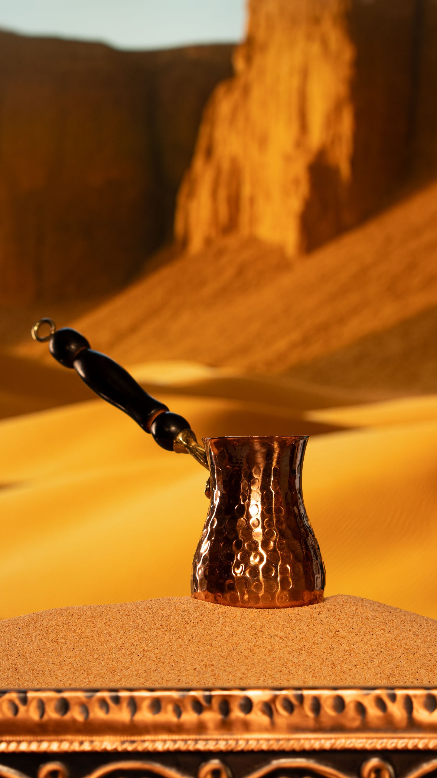 Detailed shot of the artisanal wooden handle on a heavy-duty stainless steel and copper xhezve.