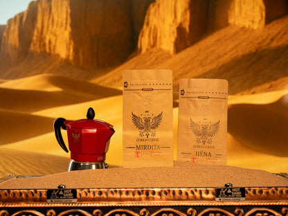 Mirdita and Hëna coffee bags with a red Moka pot, offering both bold Colombian dark roast and organic decaf options.