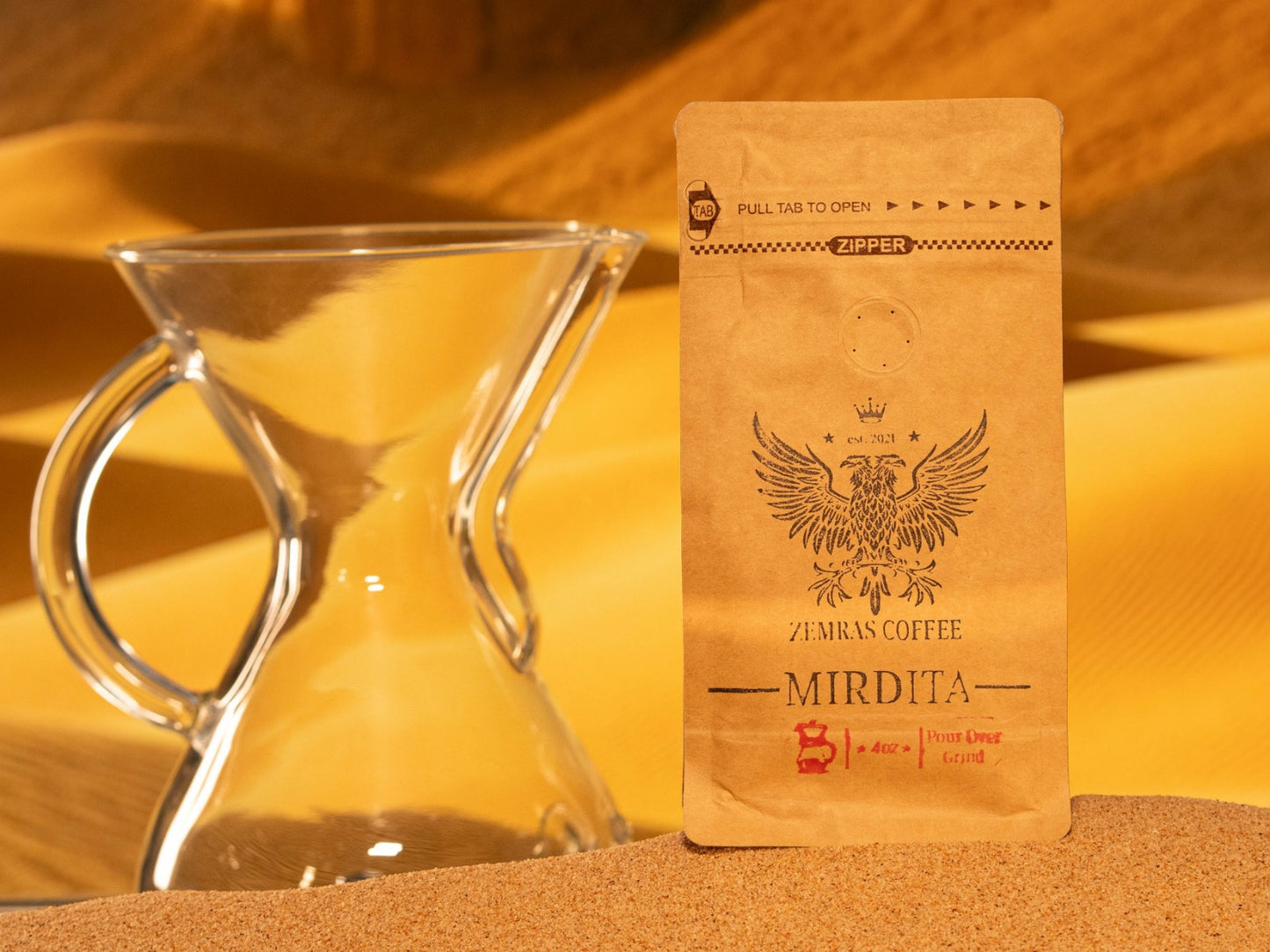Mirdita Colombian dark roast coffee bag for pour-over, featuring a glass carafe and roasted with Enderly Coffee in Charlotte.