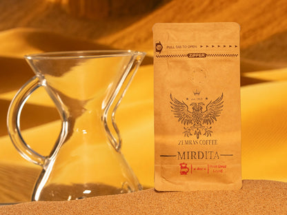 Mirdita Colombian dark roast coffee bag for pour-over, featuring a glass carafe and roasted with Enderly Coffee in Charlotte.