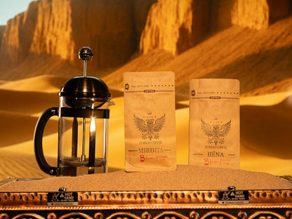 Mirdita and Hëna specialty coffee bags with a French press on a sand-brewing station, roasted in Charlotte by Enderly Coffee.