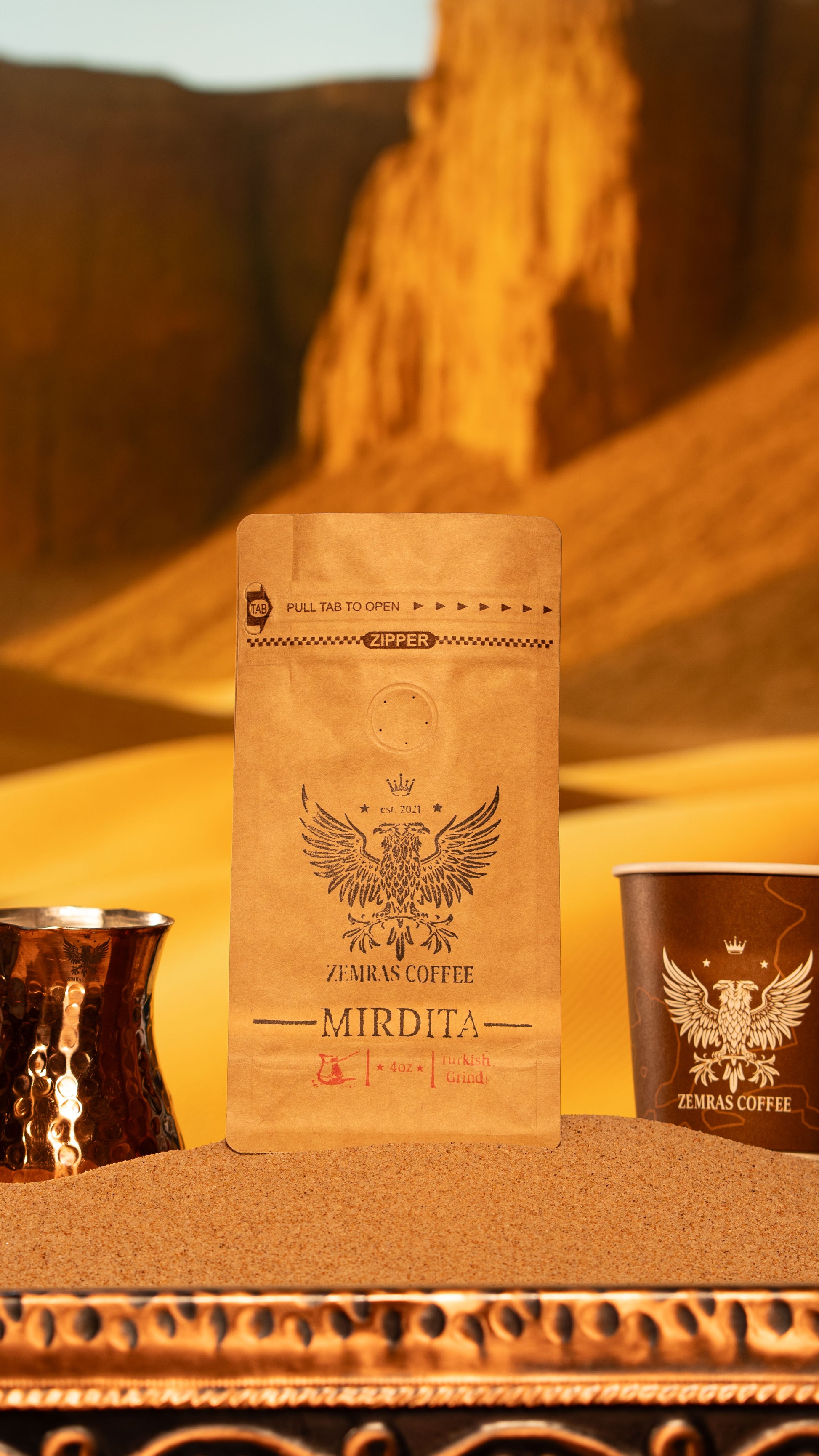 Vertical ritual shot of Mirdita Turkish coffee bag and branded cup, representing clarity and a focused morning.